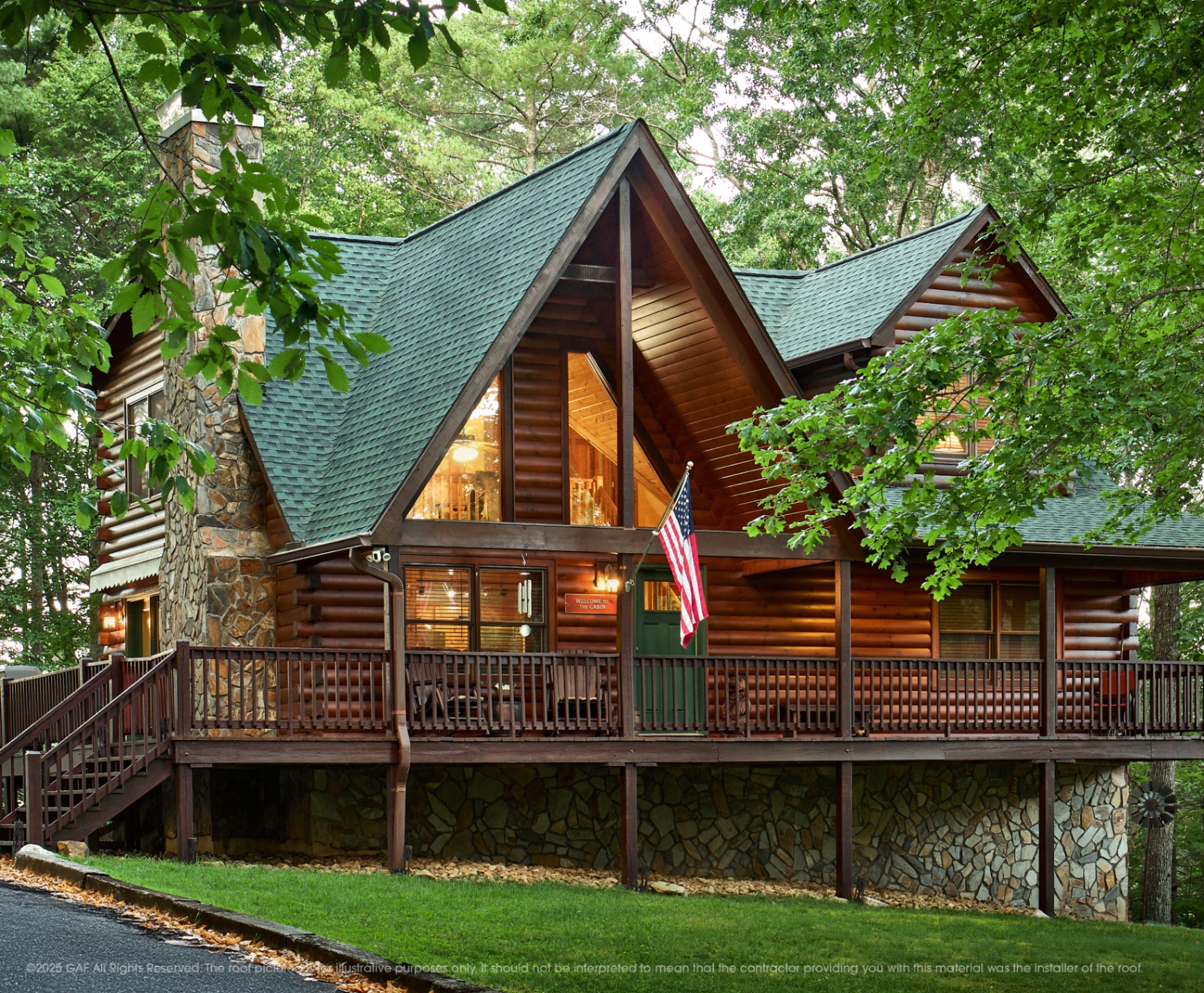 Log cabin with a Hunter Green GAF shingle roof