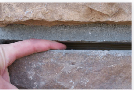 Inspecting a cracked foundation slab during a repair assessment