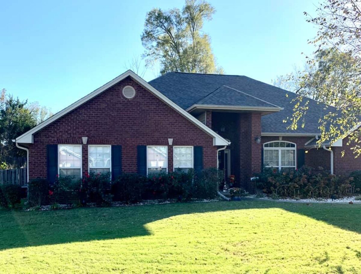 New black shingle roof on a brick ranch home