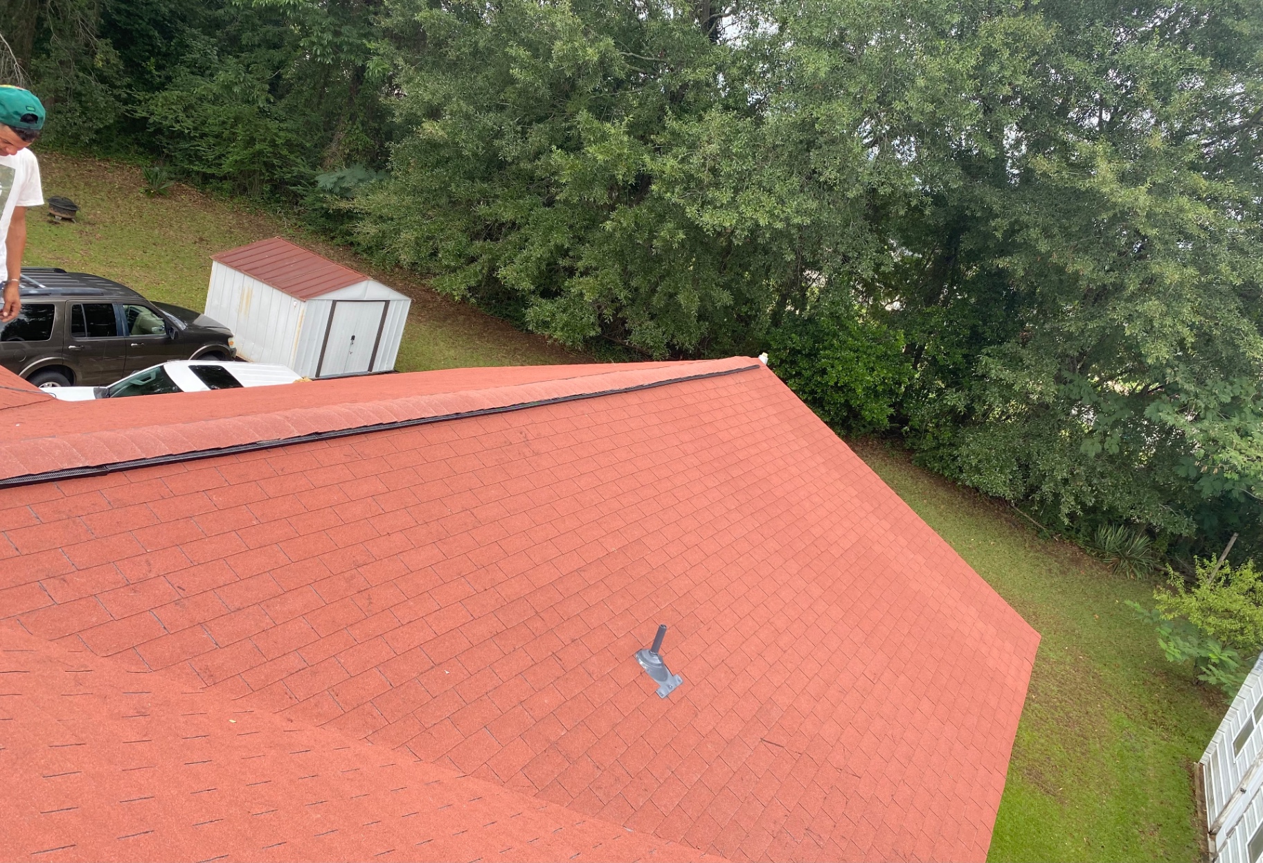 Aerial view of a completed red shingle roof replacement