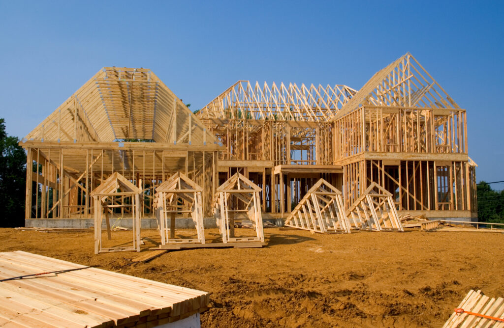 Multi-gable home framing with roof trusses and dormers under construction