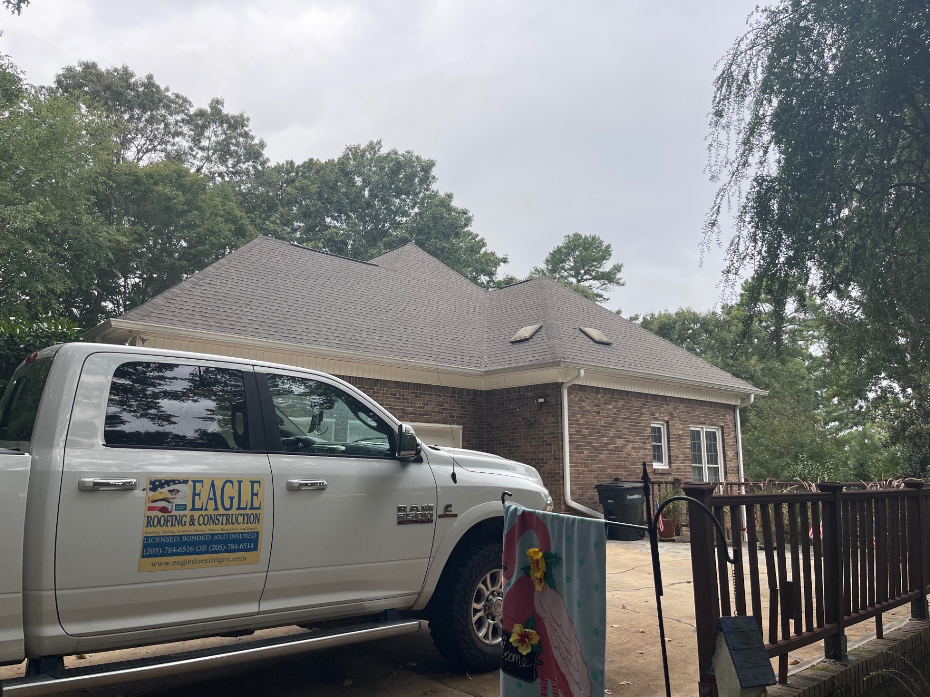 Eagle Roofing truck parked in front of a brick home during a roof inspection and documentation visit