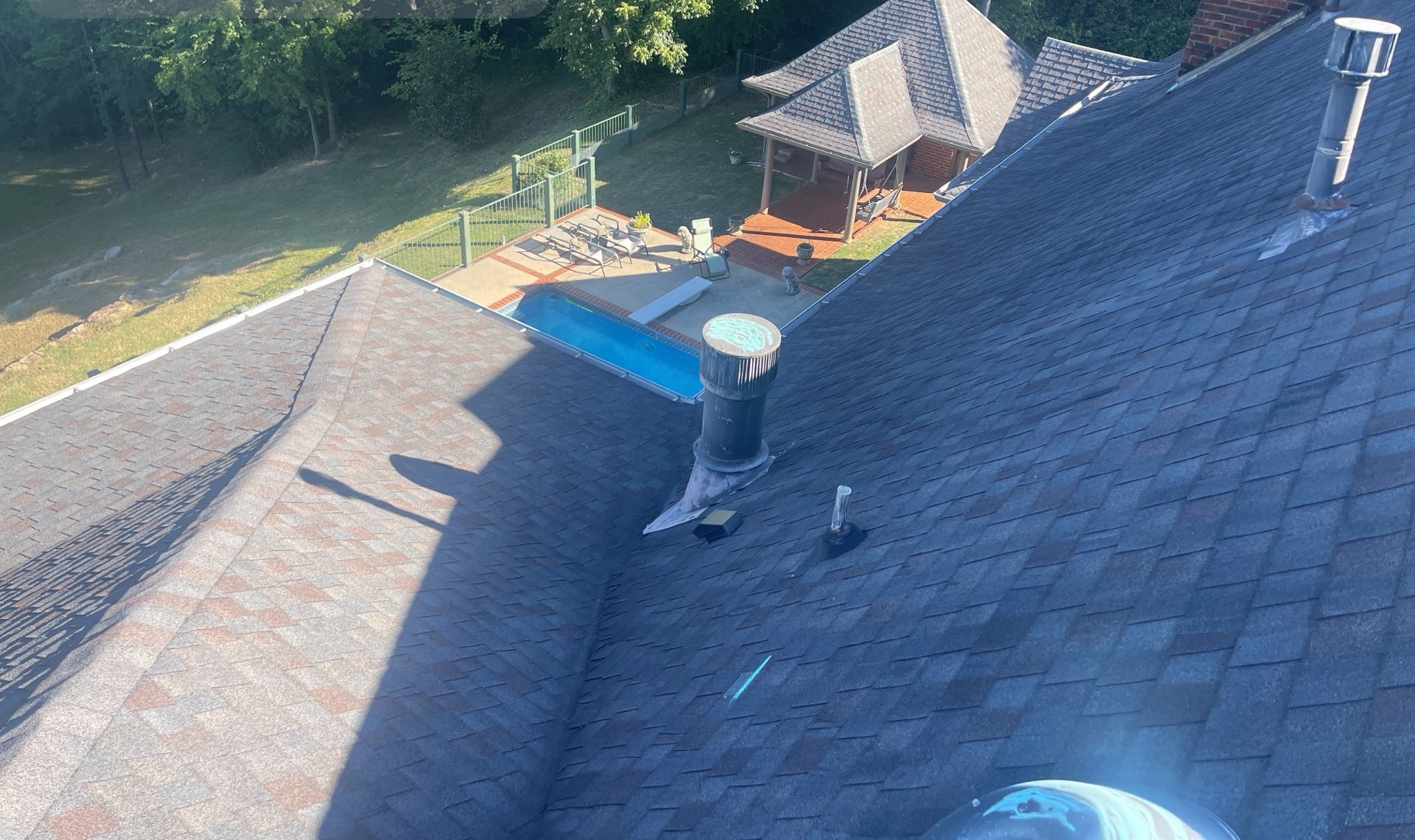 Aerial view of the roof on a hilltop pool estate before replacement