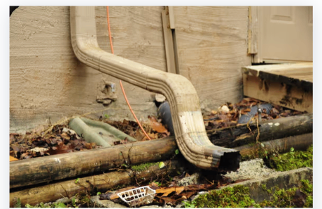 Downspout and drainage work to protect a home's foundation