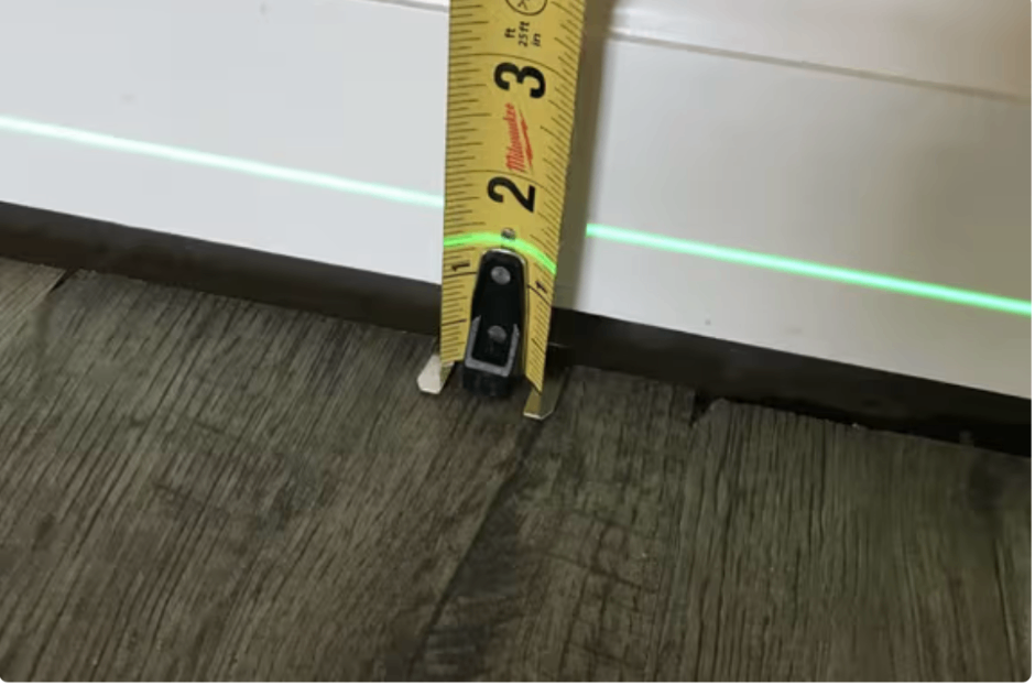 Tape measure showing floor settling and unevenness from foundation movement