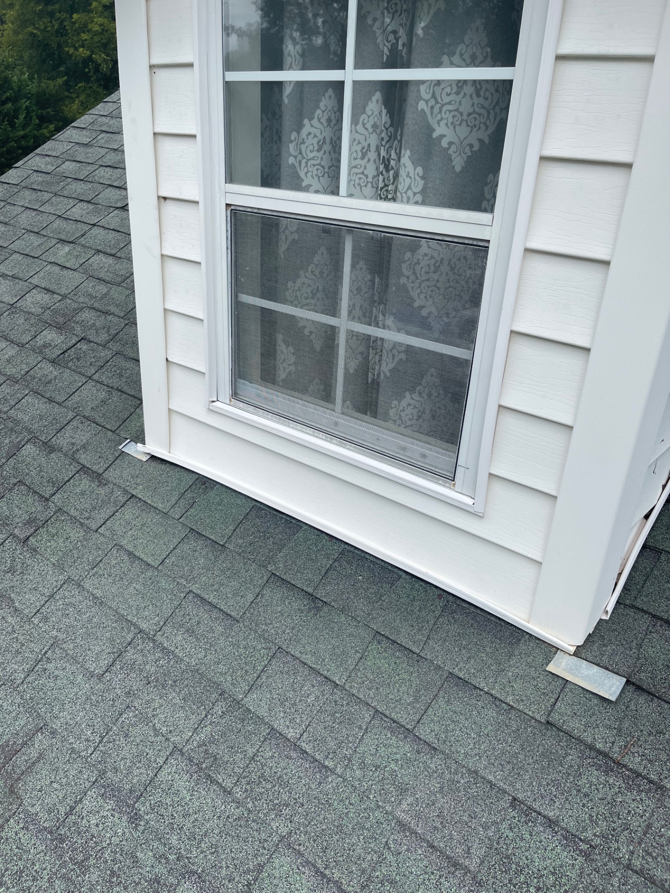 Dormer window and apron flashing detail shown on an asphalt shingle roof